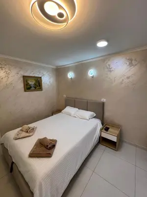 a bedroom with a large bed with white sheets at Paradiso1 in Vračar (historical)