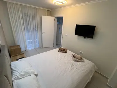 a bedroom with a bed and a flat screen tv at Paradiso1 in Vračar (historical)