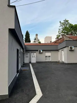 an empty parking lot in front of a building at Paradiso1 in Vračar (historical)