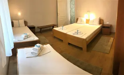 a hotel room with two beds with towels on them at Kona Apartment in Belgrade