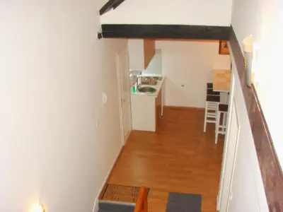 a hallway leading to a kitchen and a living room at Kona Apartment in Belgrade