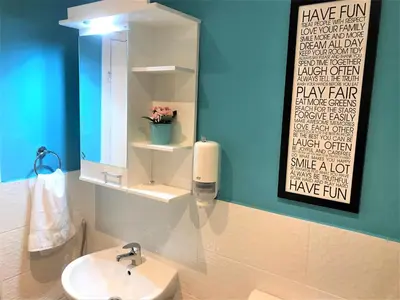 a bathroom with a sink and a mirror at Kona Apartment in Belgrade