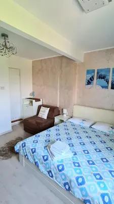 a bedroom with a large bed and a couch at Arena Dream Studio in Belgrade