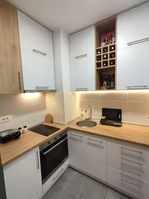 a kitchen with white cabinets and a sink at MoonZE apartman, free parking in Novi Grad