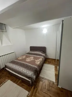 a small bedroom with a bed in a room at Rio Apartman in Belgrade
