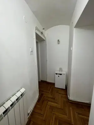 an empty room with white walls and wooden floors at Rio Apartman in Belgrade