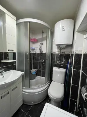 a bathroom with a toilet and a sink and a shower at Rio Apartman in Belgrade