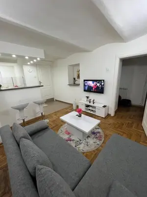 a living room with a couch and a tv at Rio Apartman in Belgrade