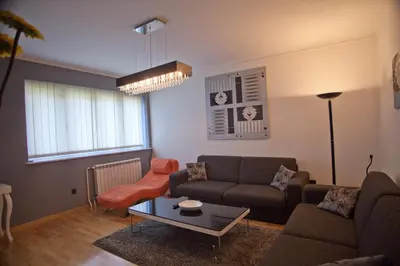 a living room with a couch and a table at Angel Apartment in Belgrade