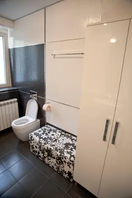 a bathroom with a toilet and a door with a stool at Angel Apartment in Belgrade