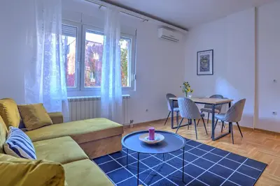 a living room with a couch and a table at Belgrade City Center Modern Apartment in Belgrade