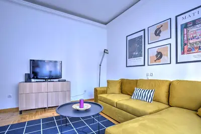 a living room with a couch and a tv at Belgrade City Center Modern Apartment in Belgrade