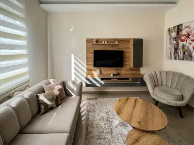 a living room with a couch and a table and a tv at Old Town Central Apartment in Belgrade