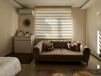 a living room with a couch and a window at Old Town Central Apartment in Belgrade