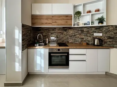 a kitchen with white cabinets and a sink at Old Town Central Apartment in Belgrade