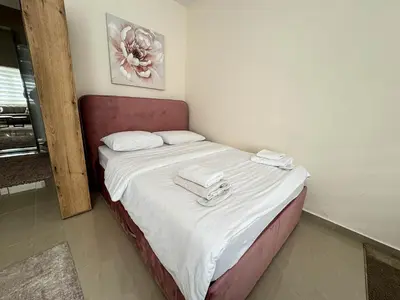 a bed in a room with two towels on it at Old Town Central Apartment in Belgrade