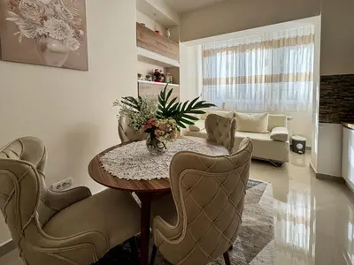a living room with a table and chairs and a couch at Old Town Central Apartment in Belgrade