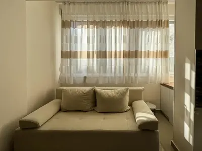 a couch in a room with a window at Old Town Central Apartment in Belgrade