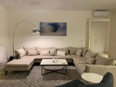 a living room with a couch and a table at Voyager 360, FREE PRIVATE PARKING in Belgrade