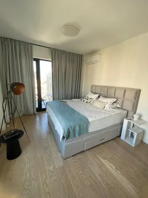 a bedroom with a large bed and a large window at Voyager 360, FREE PRIVATE PARKING in Belgrade