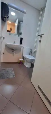 a bathroom with a toilet and a sink and a mirror at Mimoza in Novi Beograd