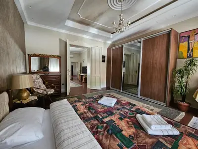 a bedroom with a bed and a living room at Zemun Center LUX 3 bedroom in Belgrade