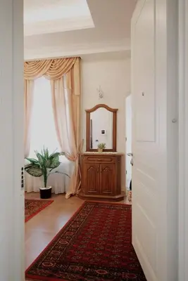 a hallway with a mirror and a dresser in a room at Zemun Center LUX 3 bedroom in Belgrade