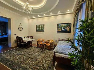 a living room with a table and a dining room at Zemun Center LUX 3 bedroom in Belgrade