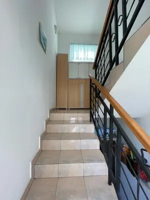 a staircase in a house with wood and tile floors at Mimoza JD in Inđija