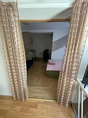 a view of a room with a bed and curtains at Mimoza JD in Inđija