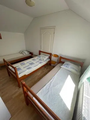 two beds in a small room with twothirdsessions at Mimoza JD in Inđija