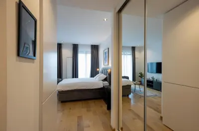 a bedroom with a bed and a mirror at Belgrade Center Apartment Lux 1 in Belgrade