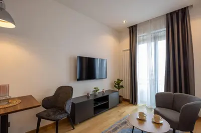 a living room with a flat screen tv on a wall at Belgrade Center Apartment Lux 1 in Belgrade