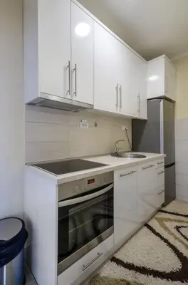 a kitchen with white cabinets and a sink at City View 00-24 in Belgrade
