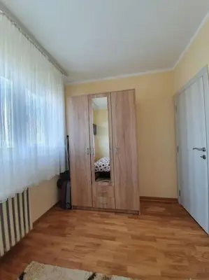 an empty room with a wooden door and a mirror at City View 00-24 in Belgrade