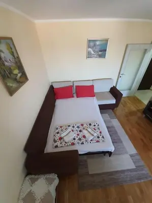a living room with a couch and red pillows at City View 00-24 in Belgrade
