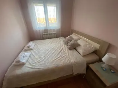 a small bedroom with a bed with towels on it at Malina 24 in Belgrade