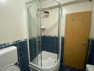a shower with a glass door in a bathroom at Malina 24 in Belgrade