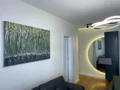 a living room with a painting on the wall at Magenta Kulina Bana in Belgrade