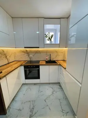 a kitchen with white cabinets and a sink and a window at Magenta Kulina Bana in Belgrade