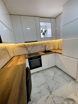 a kitchen with white cabinets and a sink and a counter at Magenta Kulina Bana in Belgrade