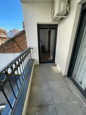 a balcony with a door on the side of a building at Magenta Kulina Bana in Belgrade