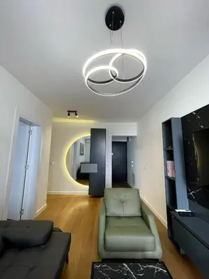 a living room with a couch and a chandelier at Magenta Kulina Bana in Belgrade