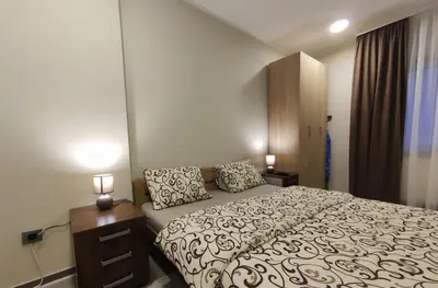 a bedroom with a bed with two pillows on it at Prenoćište Lana in Novi Banovci