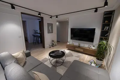 a living room with a couch and a flat screen tv at Vividlux Apartments in Arandjelovac