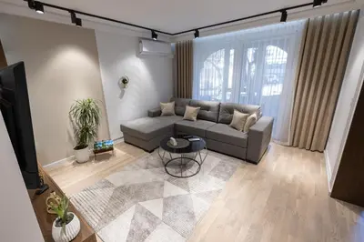 a living room with a couch and a tv at Vividlux Apartments in Arandjelovac