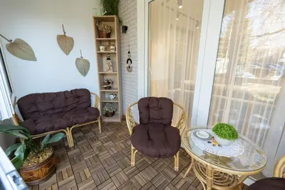 a living room with two chairs and a table at Vividlux Apartments in Arandjelovac