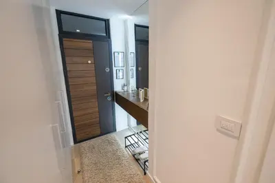 a hallway with a door leading to a bathroom at Vividlux Apartments in Arandjelovac