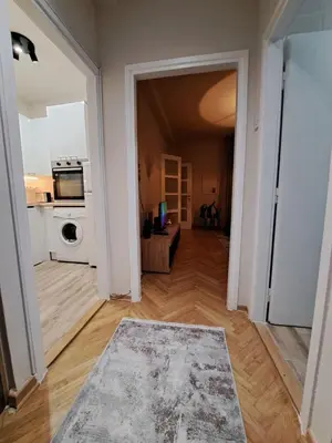 an open hallway with a kitchen and a living room at Ema's Cosy apartment in Belgrade