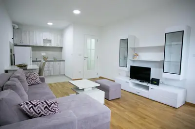 a living room with a couch and a tv at Apartman Ub in Ub